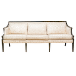 A pair of Regency style sofas with animal print gondola chairs,